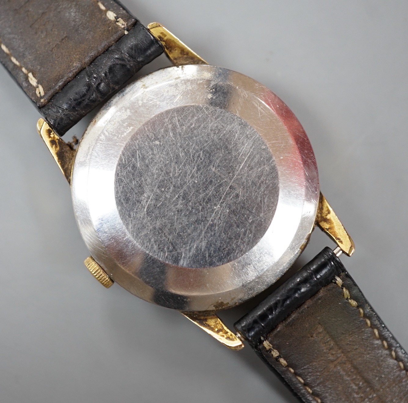 A gentleman's steel and gold plated Omega manual wind wrist watch, on associated leather strap.